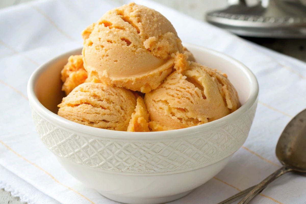 Three luscious scoops of homemade orange creamsicle ice cream