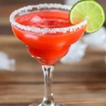 Delicious homemade strawberry margarita with salted rim, ice, and lime garnish, showcasing a fresh strawberry margarita recipe.
